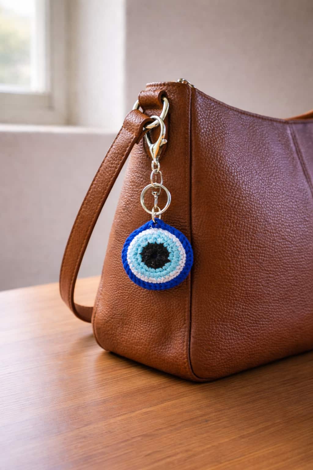 Evil eye crochet bag charm on leather bag